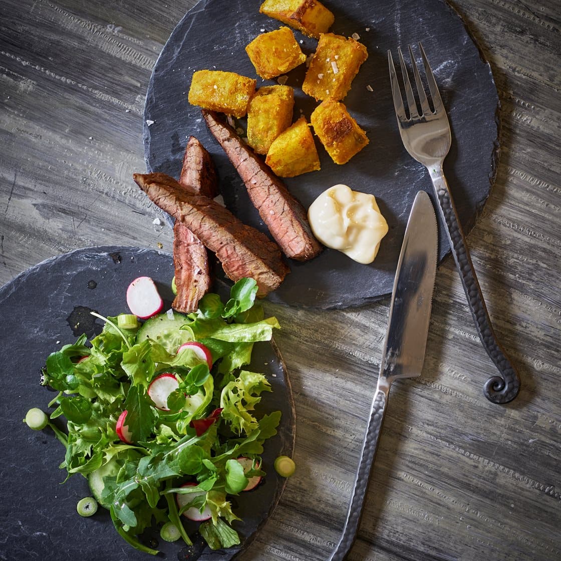 Hvidløgsmarineret flanksteak med pommes gurkemeje, aioli og forårssalat